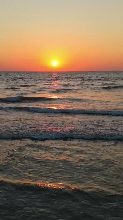 Sunset over Calm Ocean Waves Video. Vertical 4K Stock Footage 328069228