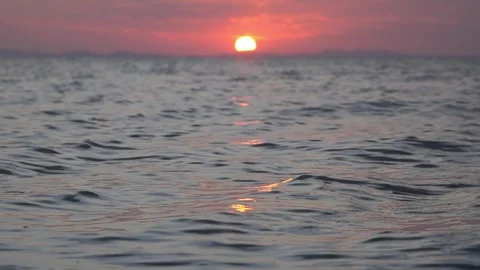 Sunset Over Calm Ocean Waves Reflecting Pink Sky on a Tranquil Evening Horizon Stock Footage 337414225
