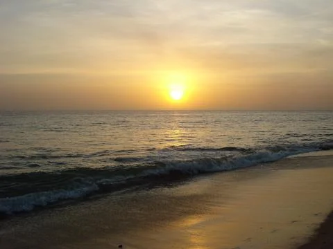 Sunset over calm ocean waves Stock Photos