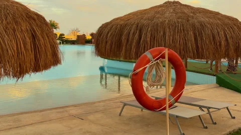 Sunset Over Calm Resort Waters. Quiet Lagoon With Relaxing Sunshade And Safety 库存影片 337939259