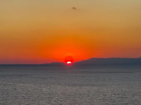 Sunset over calm sea creating peaceful and emotional atmosphere Stock Photos