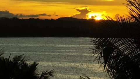 Sunset over calm sea with distant hills. Siargao, Philippines. Stock Footage 321103594