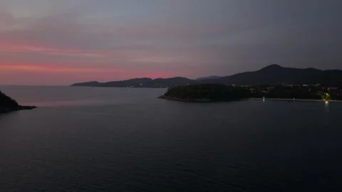 Sunset over calm sea with distant islands and colorful sky reflections Video stock 337417554