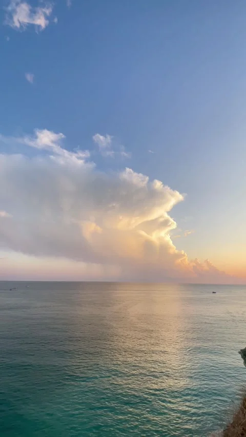 Sunset over the calm sea with dramatic pink clouds reflecting in the water Stock Footage 293065401