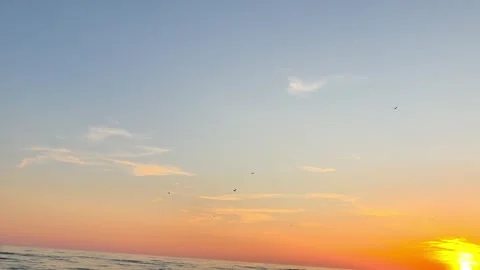 Sunset Over Calm Sea with Gentle Waves and Orange Evening Sky Stock Footage 340602696