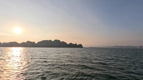 Sunset over a calm sea, limestone rock islands of Ha Long bay, Vietnam. Stock Footage 302327368