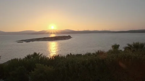 Sunset Over Calm Sea with Small Island Stock Footage 282931552
