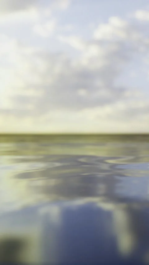 Sunset over calm water with clouds and reflections in the sky Stock Footage 332231930
