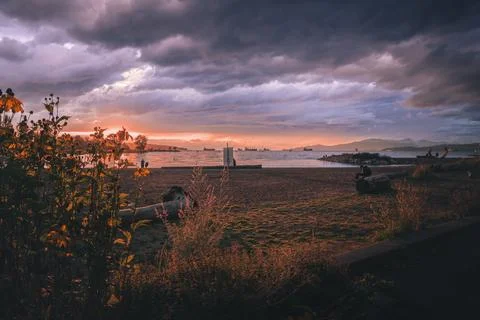 Sunset over calm water with dramatic clouds Stock Photos