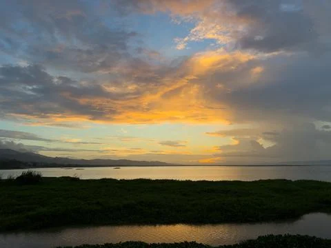 Sunset Over Calm Water With Dramatic Clouds Foto stock