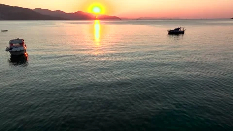 Sunset Over Calm Waters with Boat Stock Footage 282931171
