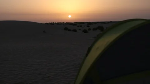 Sunset over a camping tent in the middle of desert Stock Footage 92977635
