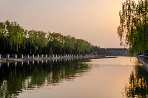Sunset over canal lined with trees in Beijing Stock Photos