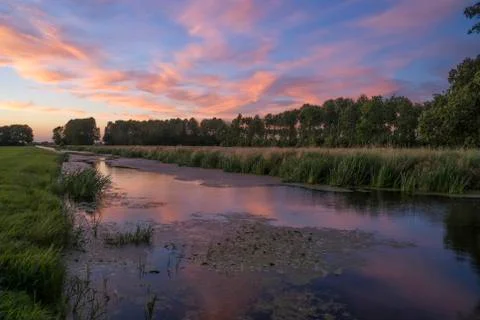 Sunset over a canal Stock Photos