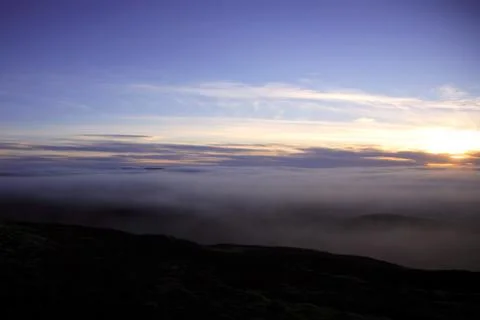 Sunset over a canopy of cloud Stock Photos