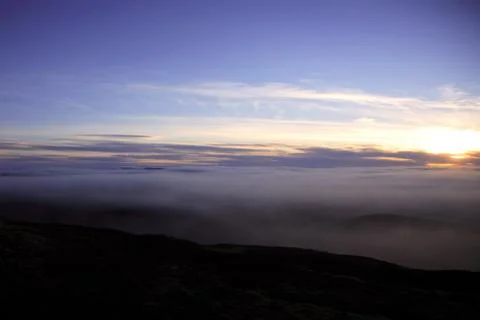 Sunset over a canopy of cloud Stock Photos