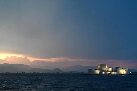 Sunset over the castle Bourtzi in Nafplio, Peloponnese, Greece Фото