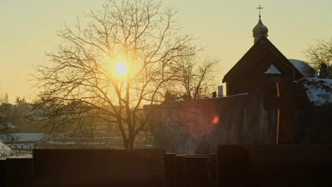 Sunset over a cemetery with a silhouette of a leafless tree, Orthodox chapel Stock Footage 302887551