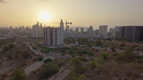 Sunset over city with construction and buildings in background Stock Footage 340192416