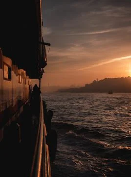 Sunset over a city from a ferry Stock Photos