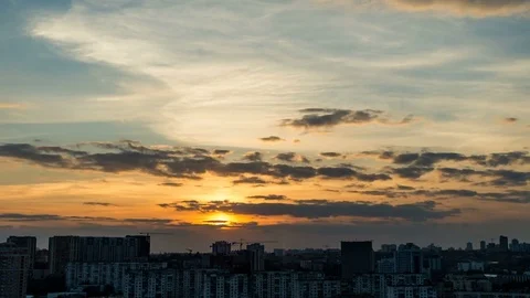 The sunset over the city from high above the city. Floating clouds Stock Footage 74738480