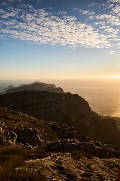 Sunset Over City Mountain Range. Twilight View Of Mountain Ridges And Glowing Фото