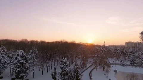 Sunset over city park covered with snow Stock Footage 72744091