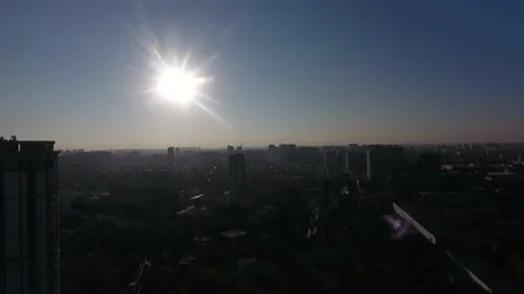 Sunset over city, in rays, sun, construction site, work completed, lifting crane Stock Footage 157817855