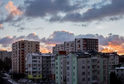 Sunset over city rooftops silhouettes, residential quarters Stock Photos