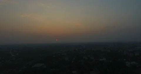 Sunset over the city in the summer Stock Footage 65560390
