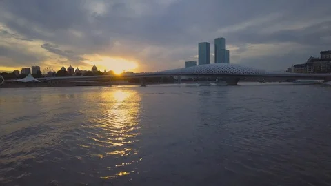 Sunset over the city. Tourists walk along the post over the river. Astana Stock Footage