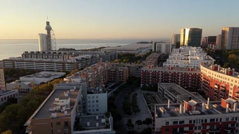 Sunset over cityscape with hotels and apartments near river; Parque das Nacoes Vídeos de archivo 346071503