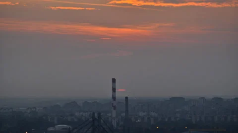 Sunset over the cityscape with industrial facility in the foreground. Stock Footage 22480963
