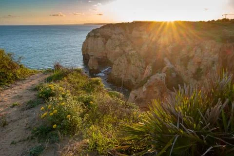 Sunset over the cliffs and beaches by Atlantic Ocean, Lagos, Algarve, Portuga Stock Photos