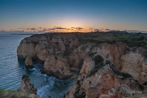Sunset over the cliffs and beaches by Atlantic Ocean, Lagos, Algarve, Portuga Stock Photos