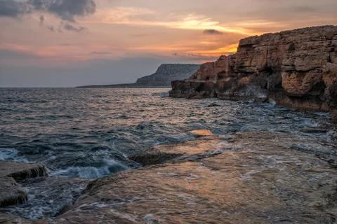 Sunset over cliffs and ocean Stock Photos