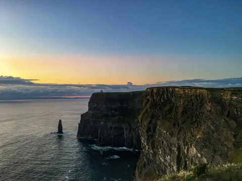 Sunset Over Cliffs of Moher with Calm Ocean Stock Photos
