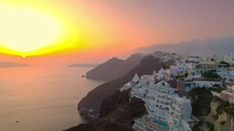 Sunset over cliffside dwellings and ocean 4K Stock Footage 314753912