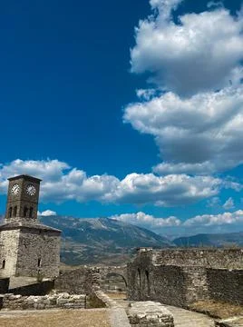Sunset over clock tower and fortress at Gjirokaster, a beautiful town in Alba Stock Photos