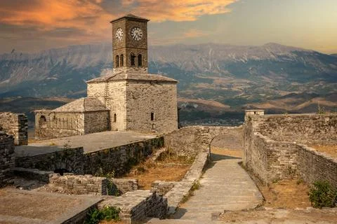 Sunset over clock tower and fortress at Gjirokaster castle, Albania Sunset... Photos