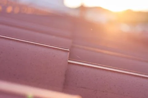 Sunset over closeup red tile roof Stock Photos