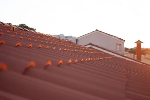 Sunset over closeup red tile roof Stock Photos
