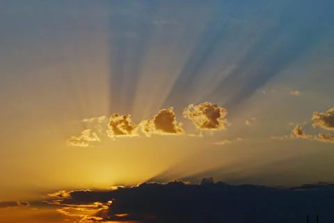 Sunset over the cloud paints the sky in orange and violet colors Stock Photos