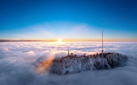 Sunset over the clouds and a TV tower Stock Photos