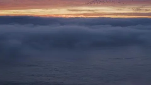 Sunset over clouds with orange and purple sky Stock Photos
