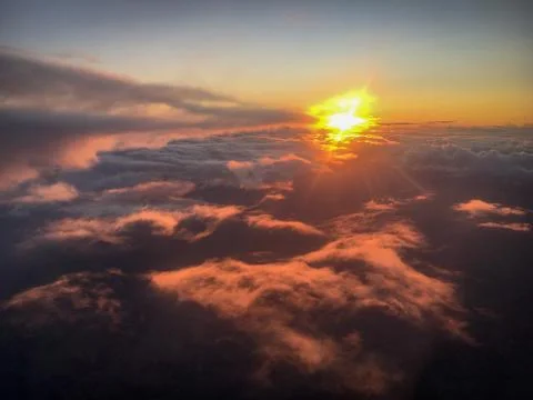 Sunset over the clouds Stock Photos