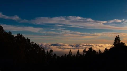 Sunset over the clouds Stock Photos