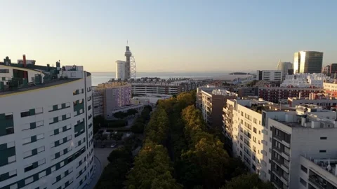 Sunset over coastal city with mixed architecture; Parque das Nacoes Video stock 346072223