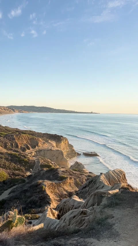 Sunset over coastal cliffs with gentle waves Stock Footage 286729139
