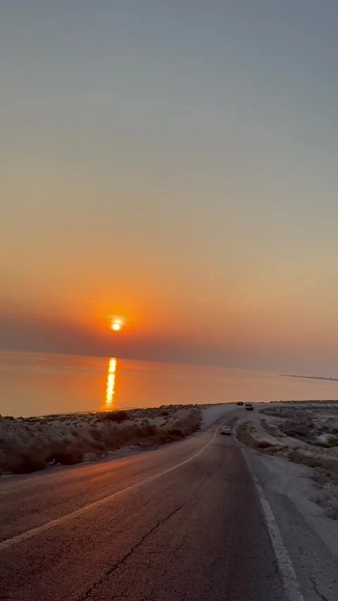 Sunset over coastal road and sea view, vertical view Stock Footage 345157211